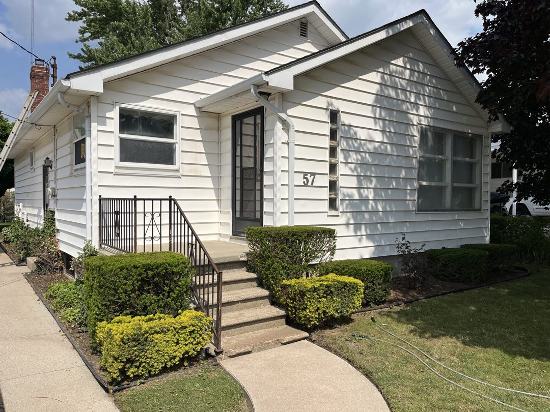 The same house front after a full soft wash